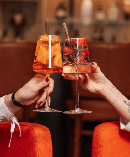 Gäste stoßen mit Getränken an
